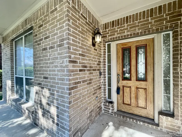 a view of a brick house with large windows