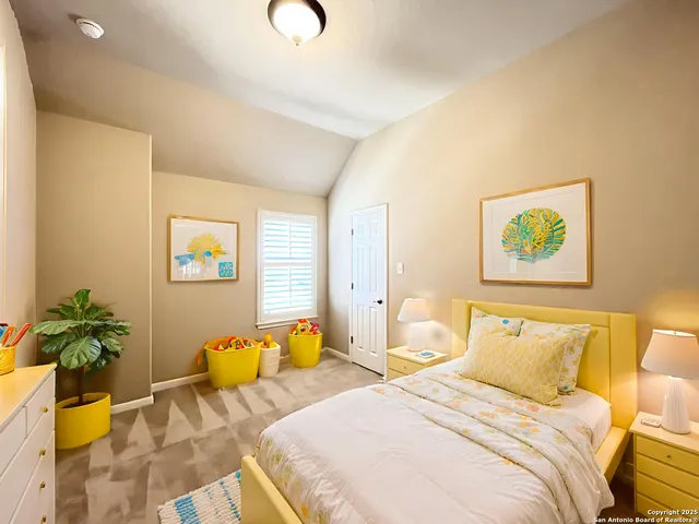 a bedroom with a bed and a potted plant