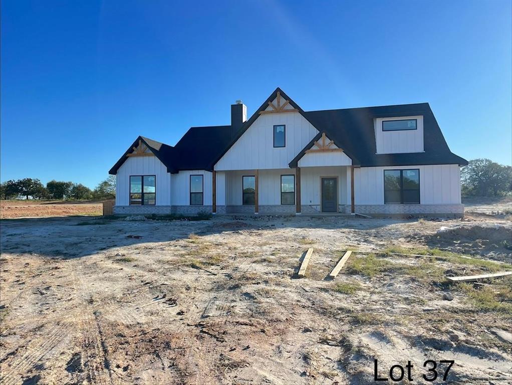 317 Jonny Boy Way Springtown, TX 76082 - Photo 1 of 34 White farmhouse with welcoming front porch