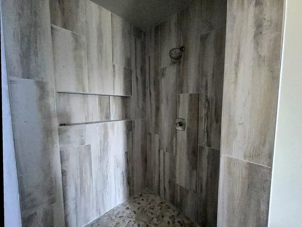 a bathroom with a glass door shower