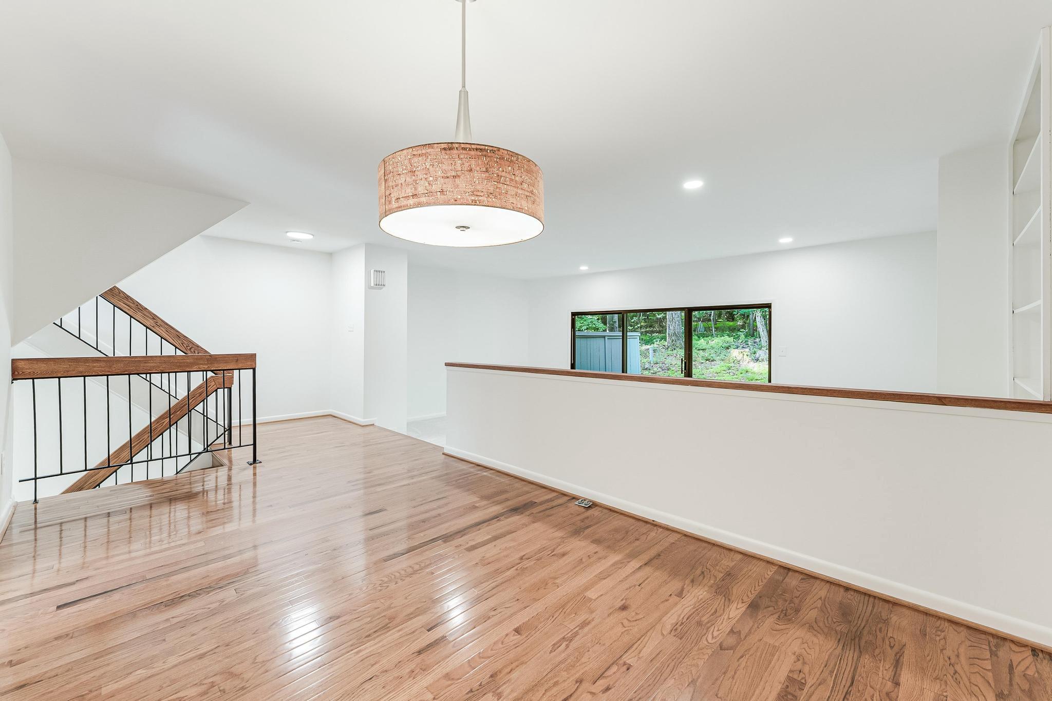 12023 Insha Court Reston, VA 20191 - Photo 27 of 52 a view of an empty room with wooden floor and a window