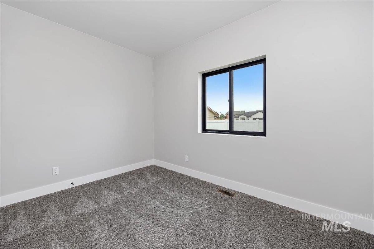 1201 Jade Drive Rupert, ID 83350 - Photo 22 of 27 Room featuring light gray walls, white baseboards, and patterned gray carpeting