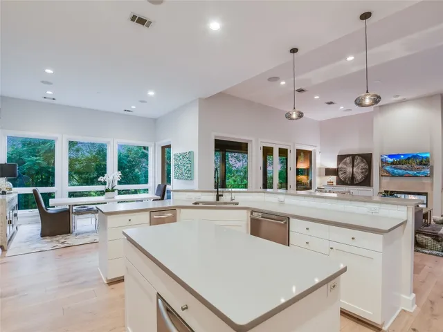 a large kitchen with a table and chairs in it