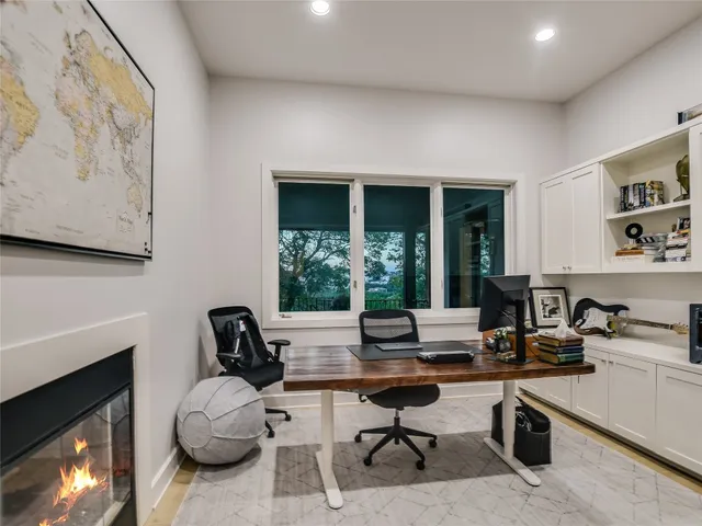 a bedroom with a bed and painting on the wall