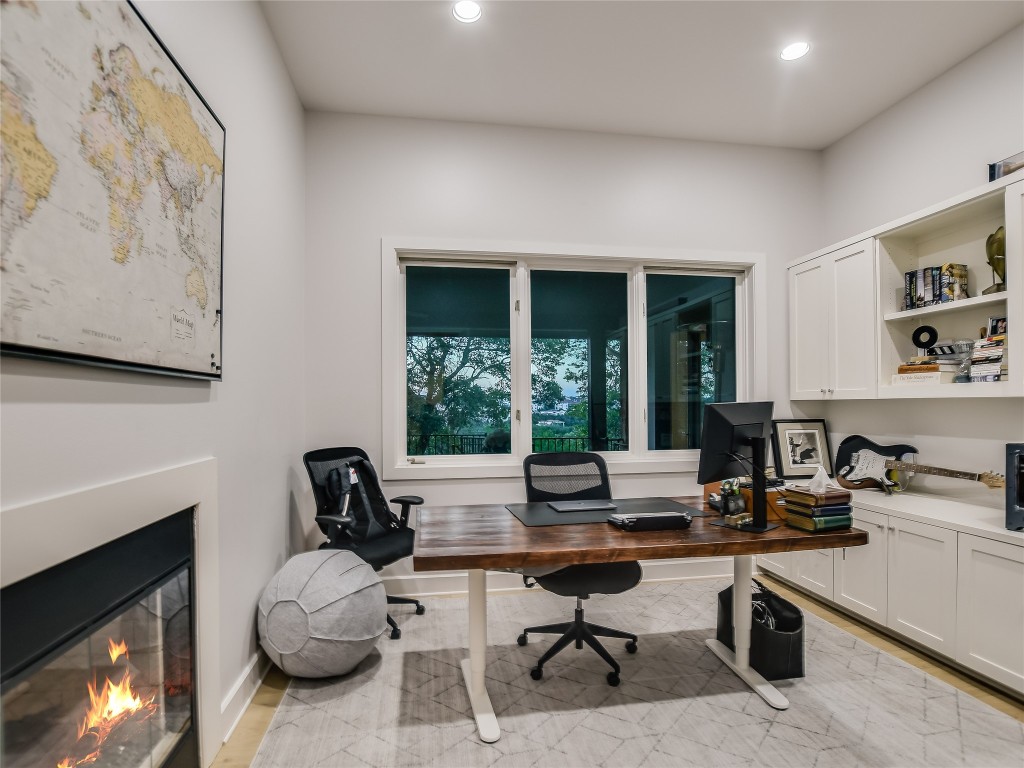 4704 Monte Carmelo Place Austin, TX 78738 - Photo 15 of 30 a living room with furniture a fireplace and a large window