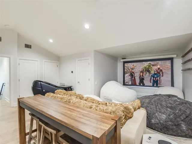 a bedroom with a bed lamp and a large window