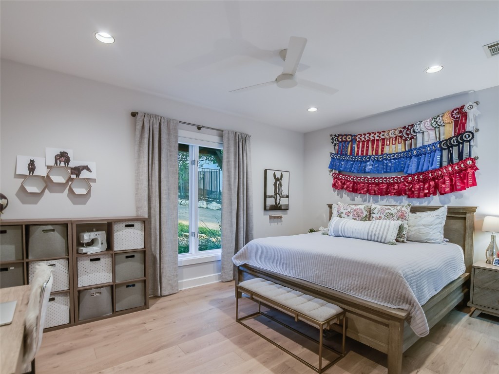 4704 Monte Carmelo Place Austin, TX 78738 - Photo 21 of 30 a bedroom with a bed a dresser and book shelf