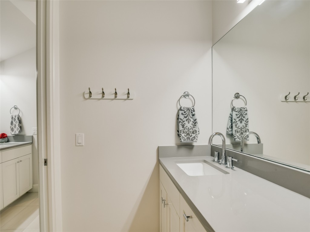 4704 Monte Carmelo Place Austin, TX 78738 - Photo 23 of 30 a bathroom with a sink and a mirror