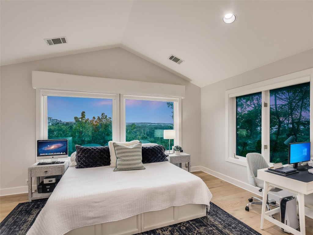 4704 Monte Carmelo Place Austin, TX 78738 - Photo 24 of 30 a bedroom with a bed and large windows