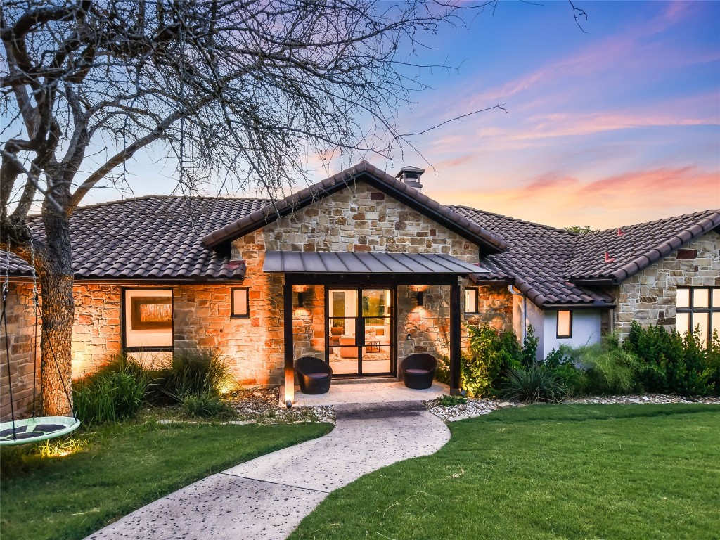 4704 Monte Carmelo Place Austin, TX 78738 - Photo 4 of 30 a front view of a house with a yard