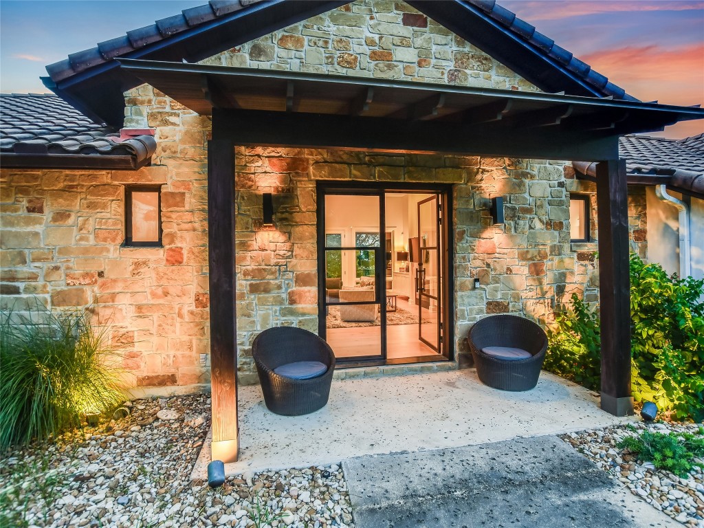 4704 Monte Carmelo Place Austin, TX 78738 - Photo 5 of 30 a view of a porch with furniture and floor to ceiling window