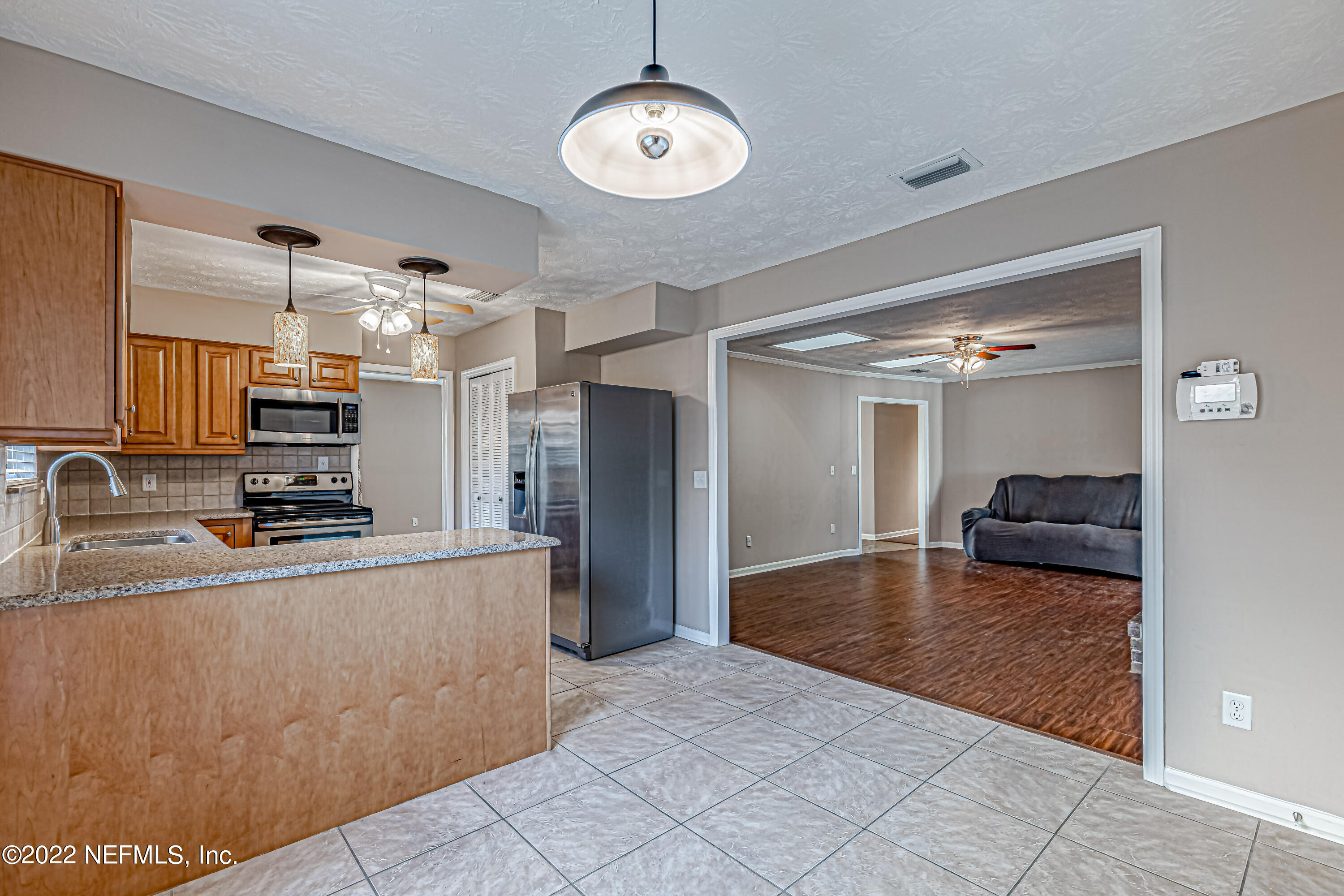 7339 Sandy Bluff Drive Jacksonville, FL 32277 - Photo 16 of 35 a large kitchen with stainless steel appliances granite countertop a sink refrigerator and cabinets