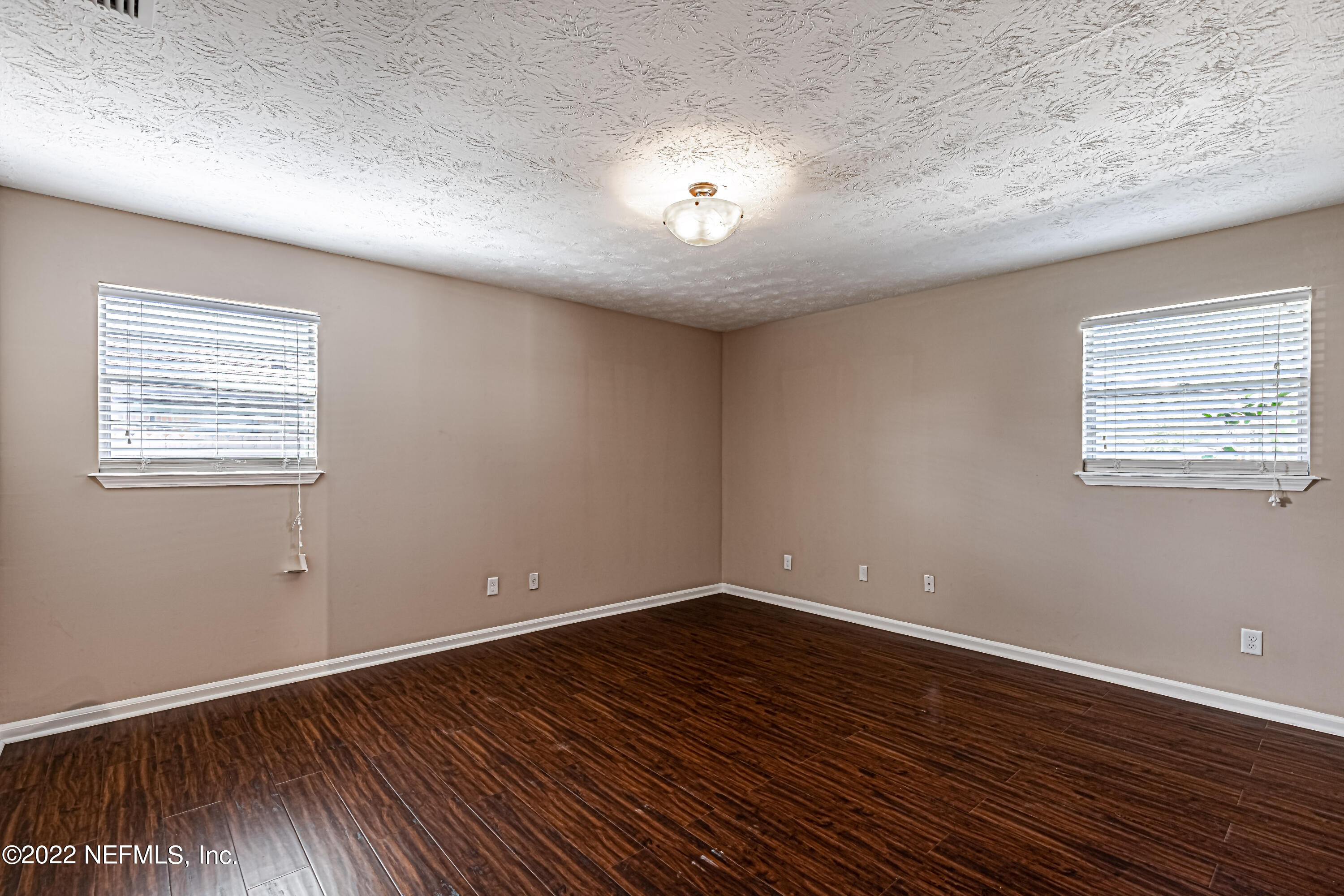 7339 Sandy Bluff Drive Jacksonville, FL 32277 - Photo 24 of 35 a view of an empty room with wooden floor and a window