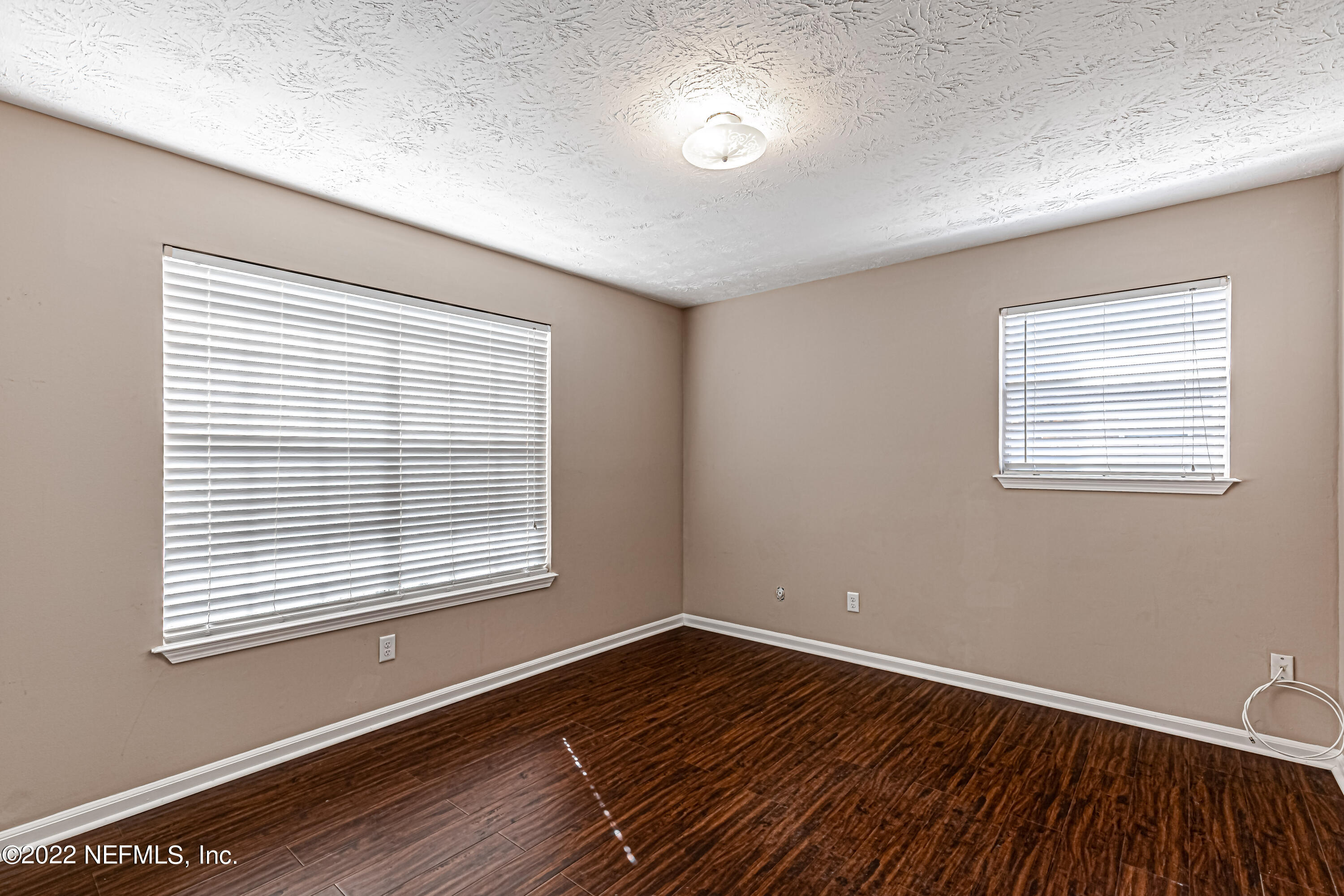 7339 Sandy Bluff Drive Jacksonville, FL 32277 - Photo 26 of 35 a view of an empty room with wooden floor and a window