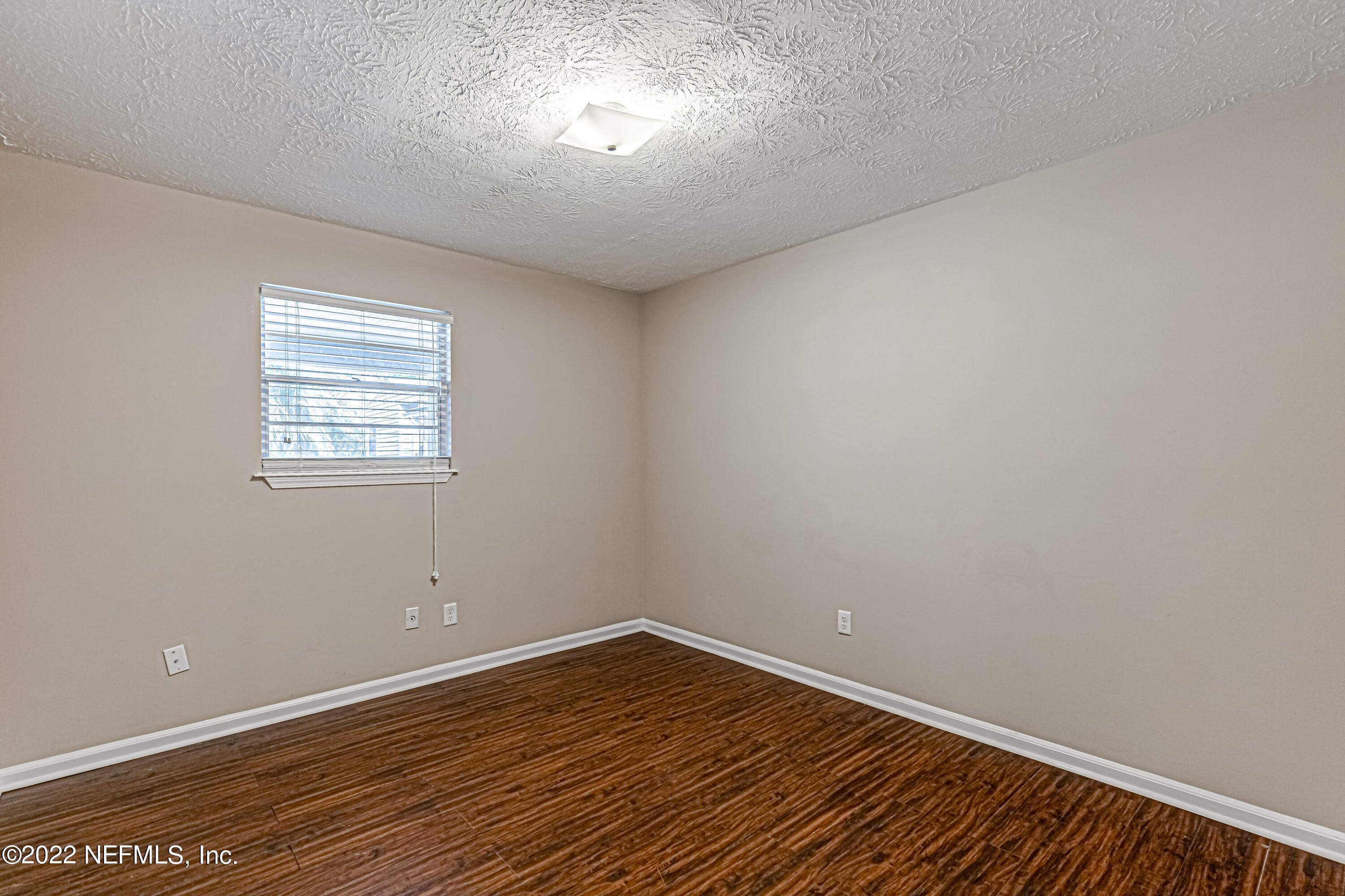 7339 Sandy Bluff Drive Jacksonville, FL 32277 - Photo 28 of 35 wooden floor in an empty room with a window