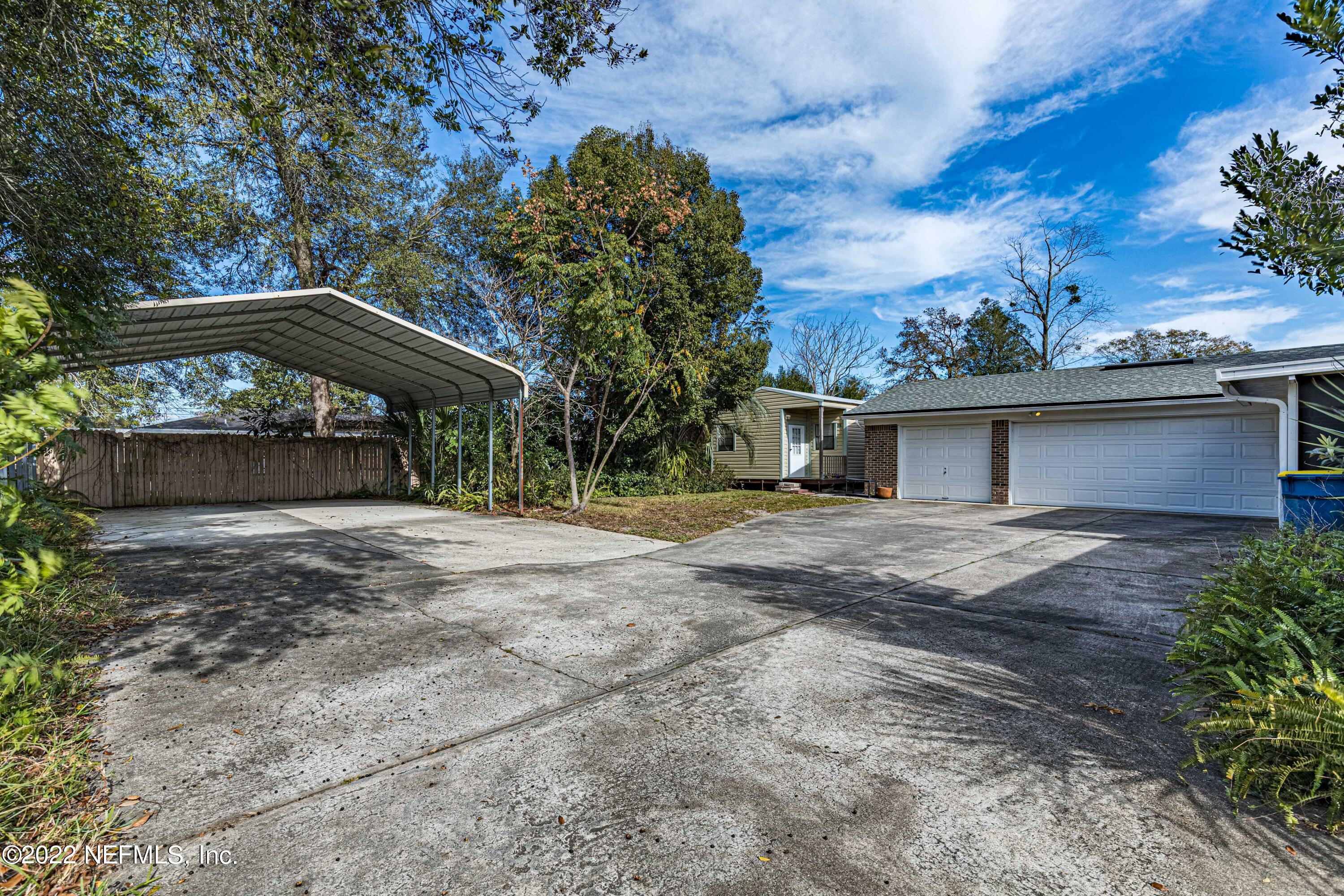 7339 Sandy Bluff Drive Jacksonville, FL 32277 - Photo 31 of 35 a front view of a house with a garden
