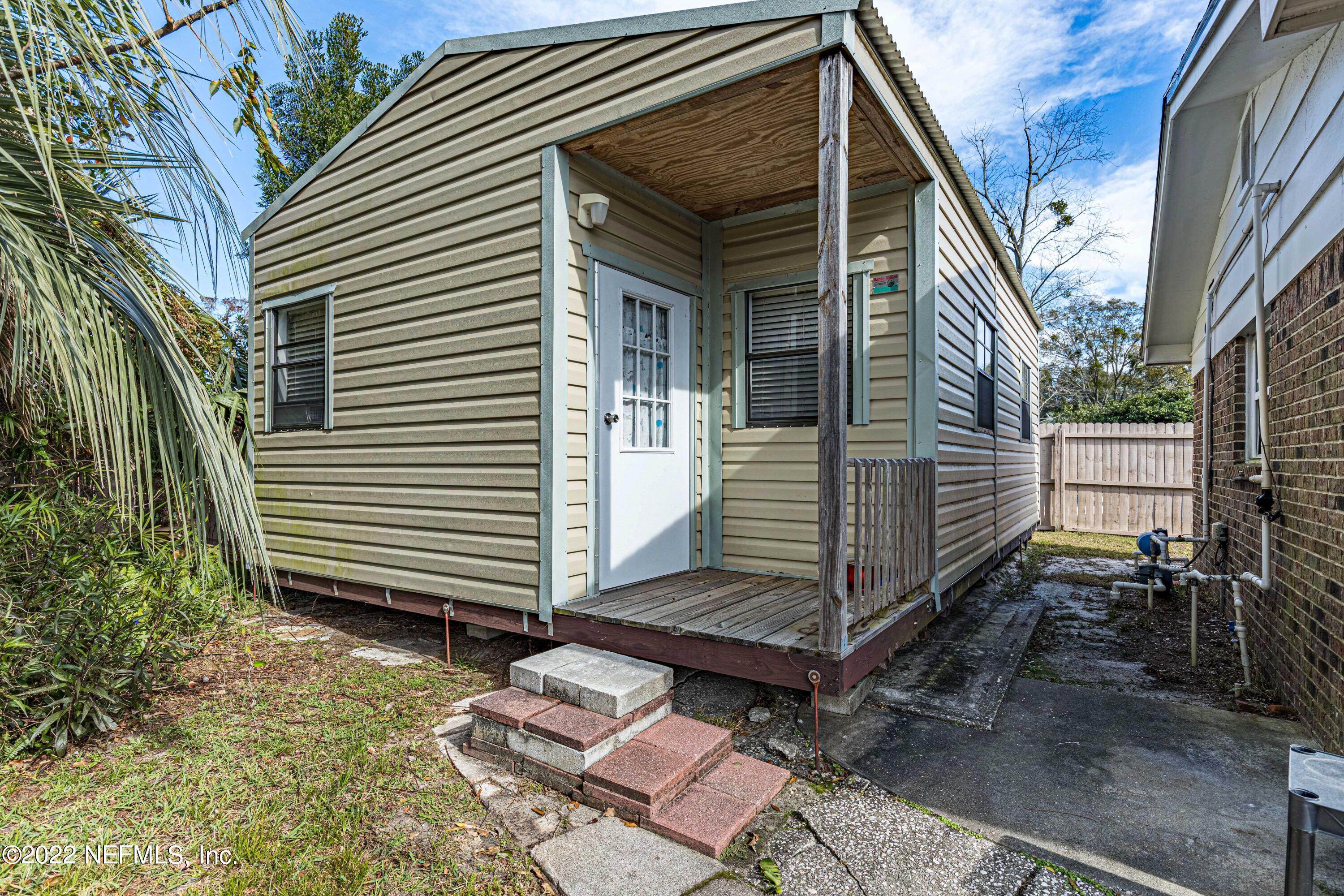 7339 Sandy Bluff Drive Jacksonville, FL 32277 - Photo 32 of 35 a view of a house with a yard and sitting area