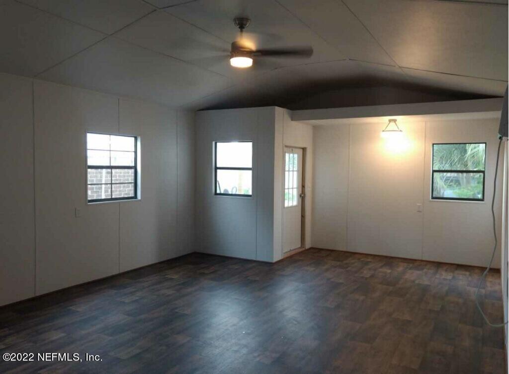 7339 Sandy Bluff Drive Jacksonville, FL 32277 - Photo 34 of 35 an empty room with wooden floor and windows