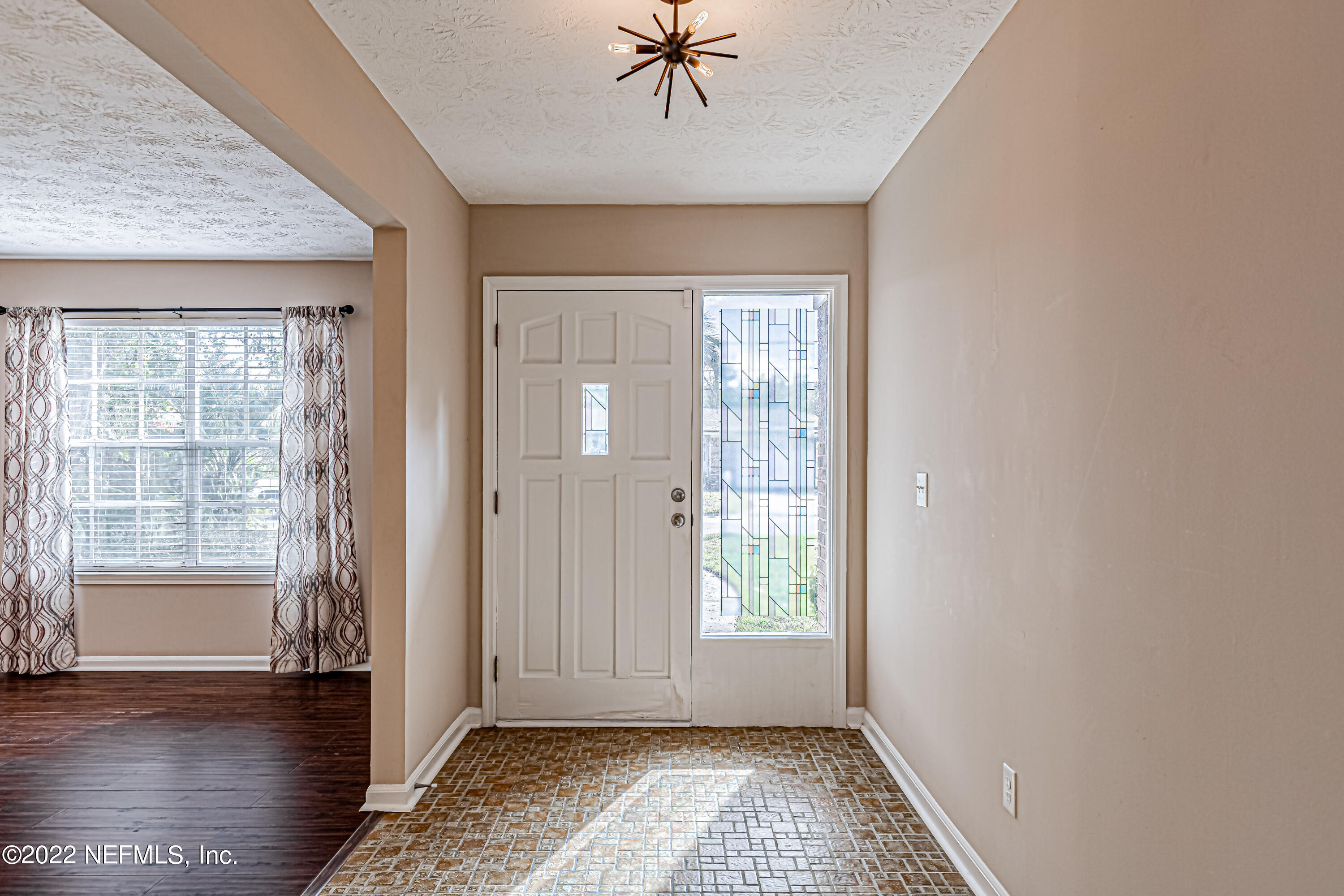 7339 Sandy Bluff Drive Jacksonville, FL 32277 - Photo 5 of 35 a view of an entryway with wooden floor and a window