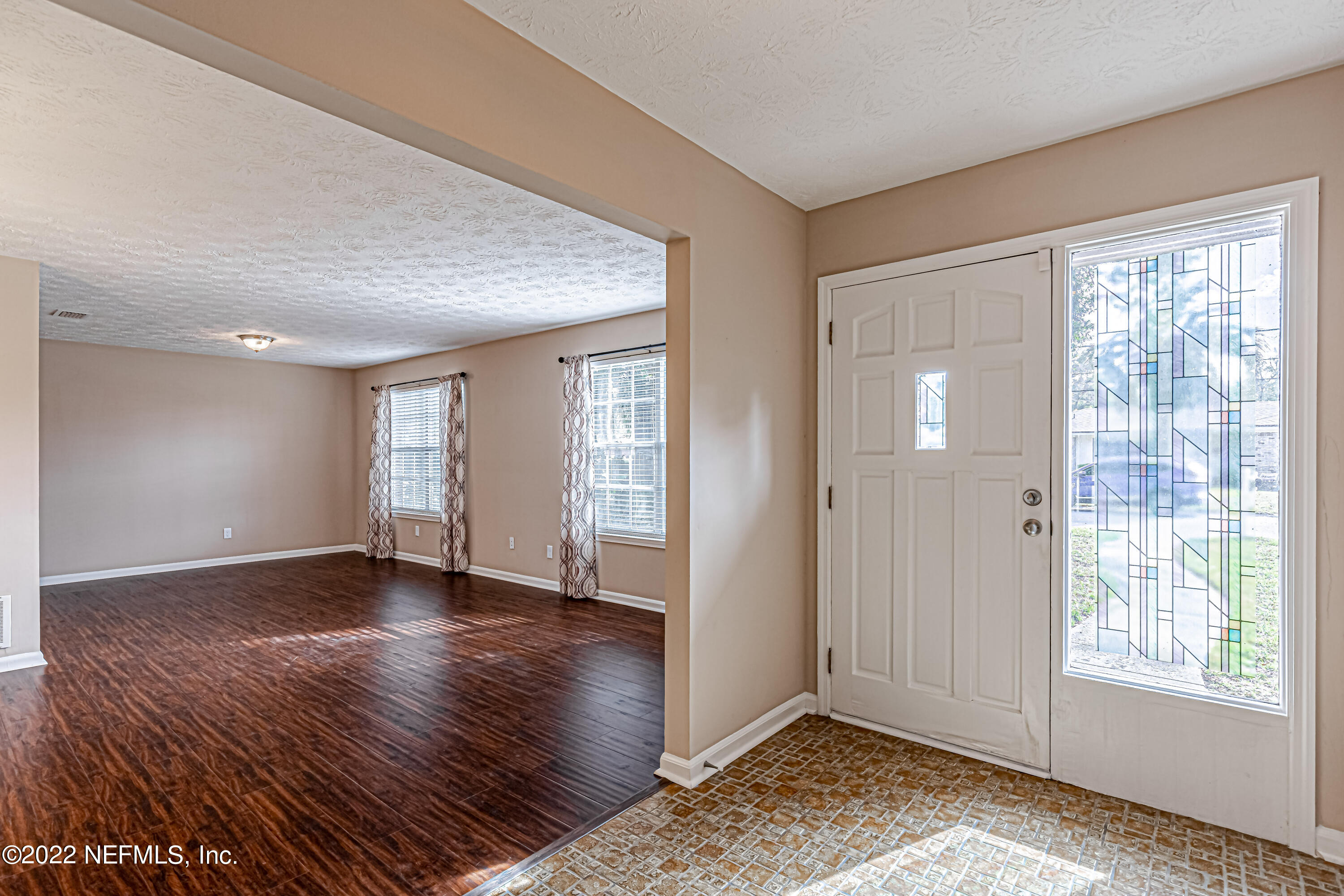 7339 Sandy Bluff Drive Jacksonville, FL 32277 - Photo 6 of 35 a view of an empty room with window and wooden floor