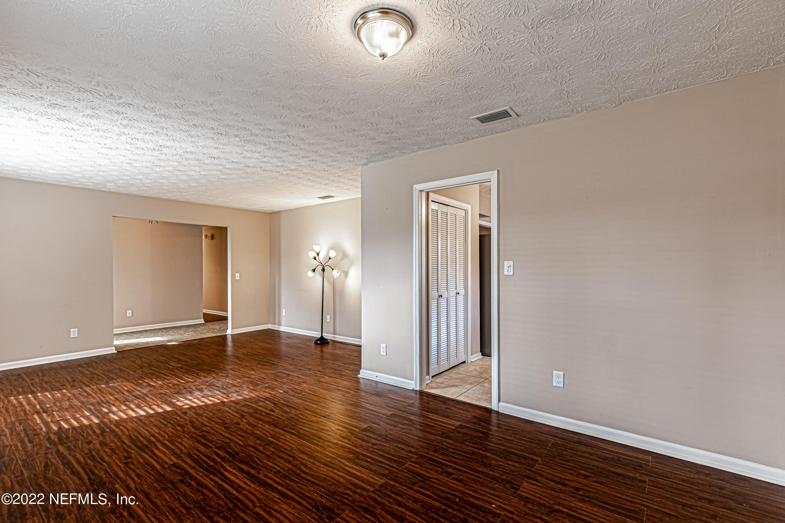 7339 Sandy Bluff Drive Jacksonville, FL 32277 - Photo 10 of 35 a view of an empty room with wooden floor and a window