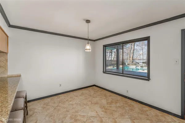 a room with dining table and a large window