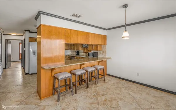 a view of a kitchen with a table and chairs