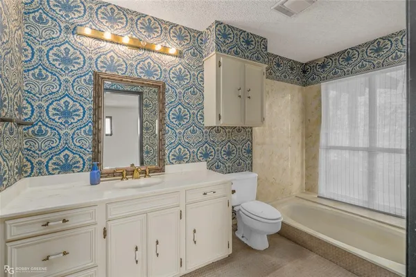 view of a hallway with a cabinet and a mirror