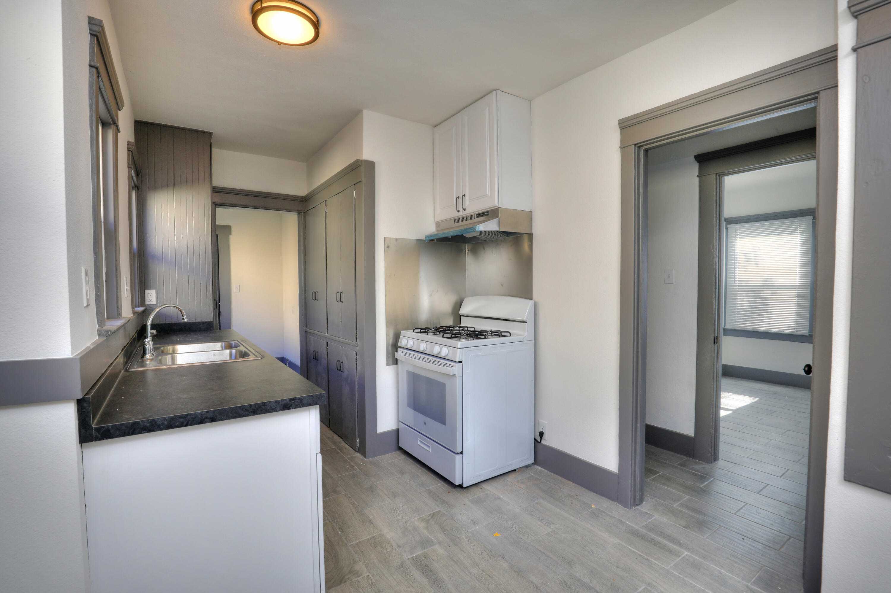 407 North Ojai Road Santa Paula, CA 93060 - Photo 6 of 7 a kitchen with kitchen island granite countertop wooden cabinets a sink and a stove