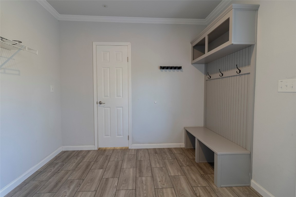 425 High View Ranch Drive Cedar Creek, TX 78612 - Photo 28 of 36 Mudroom with wood tiled floors and crown molding