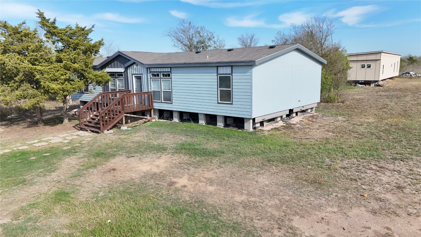 425 High View Ranch Drive Cedar Creek, TX 78612 - Photo 5 of 36 Rear view of property with a deck, a lawn, and a shingled roof