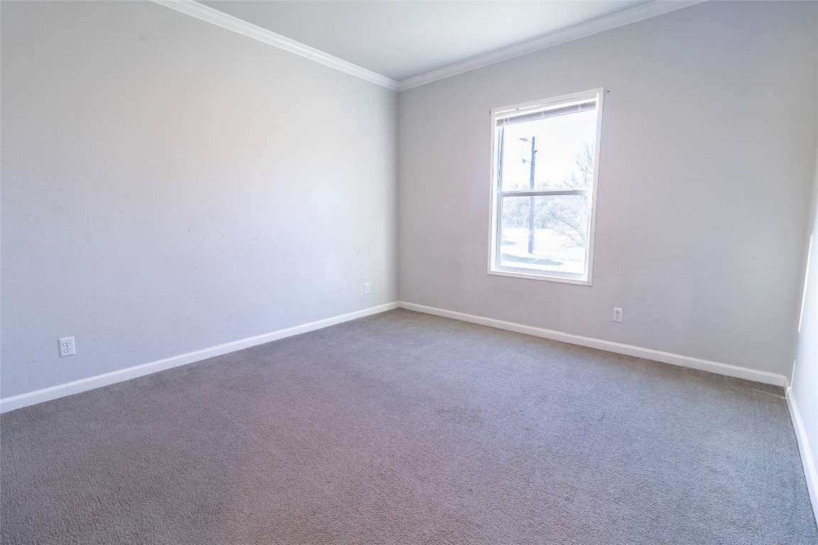 425 High View Ranch Drive Cedar Creek, TX 78612 - Photo 9 of 36 Carpeted empty room with crown molding and baseboards
