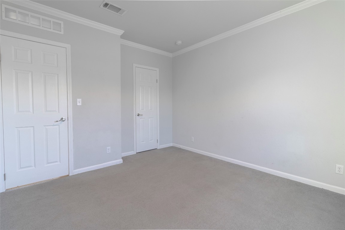 425 High View Ranch Drive Cedar Creek, TX 78612 - Photo 10 of 36 Unfurnished bedroom featuring crown molding and carpet floors