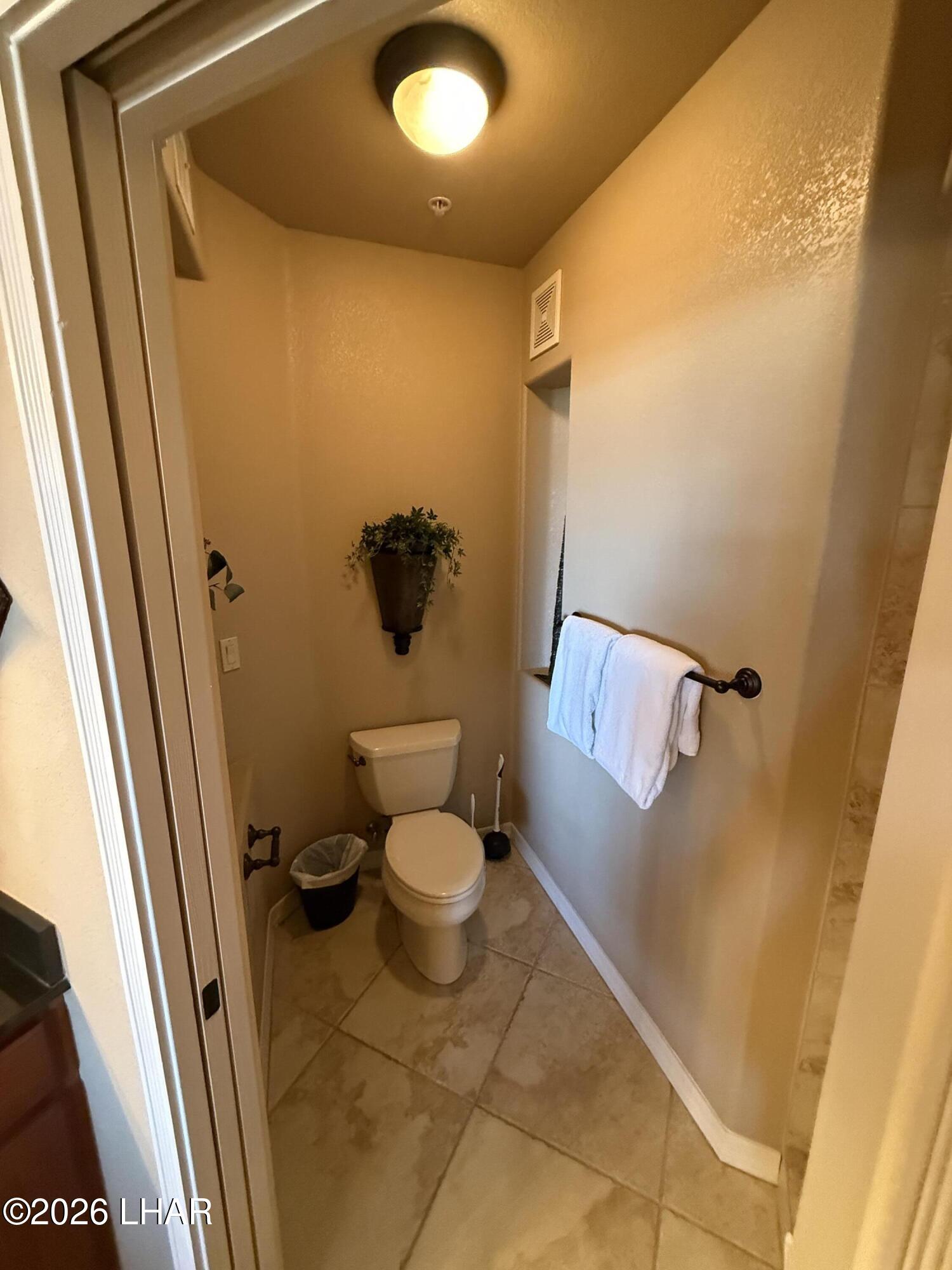 433 London Bridge Road, Unit B101 Lake Havasu City, AZ 86403 - Photo 26 of 35 a bathroom with a toilet and a shower