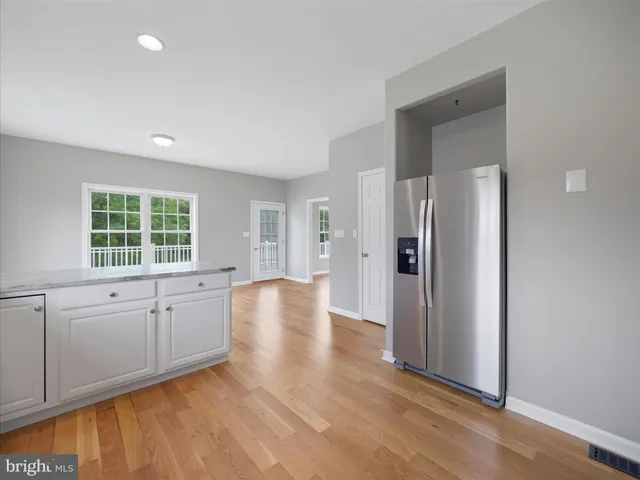 a view of a kitchen with an empty space and a window