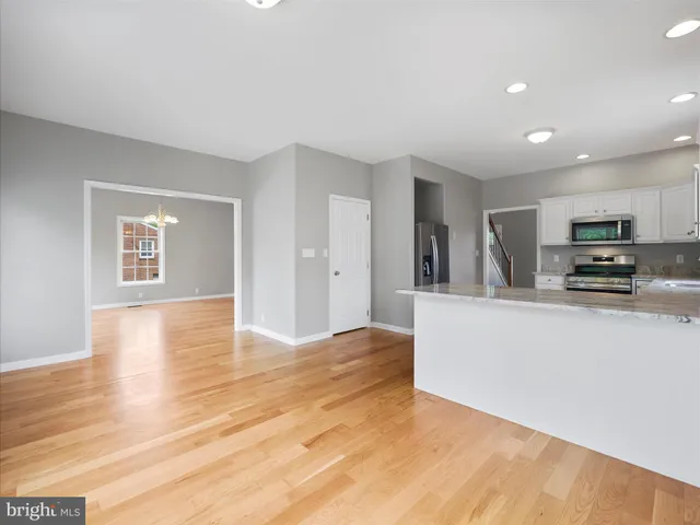 a view of kitchen with cabinets and wooden floor