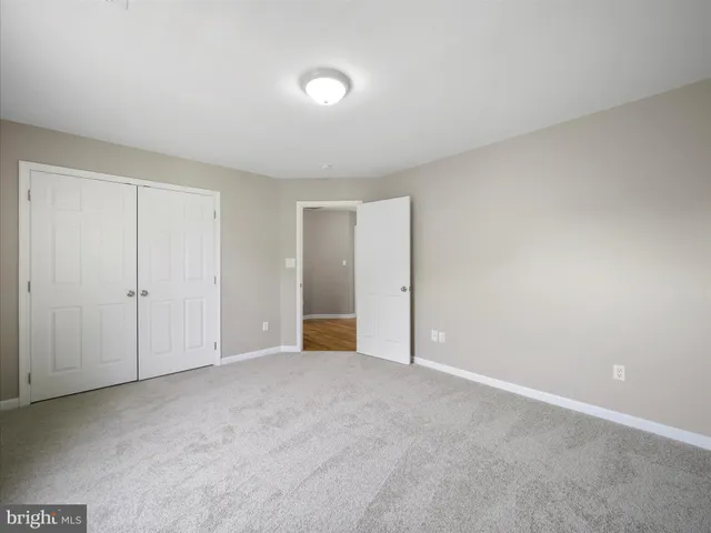 a view of a big room with windows and chandelier fan