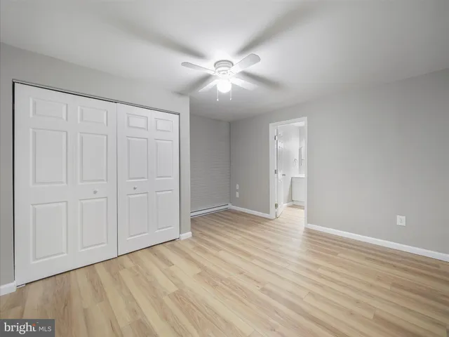 a bathroom with a toilet sink a mirror and shower