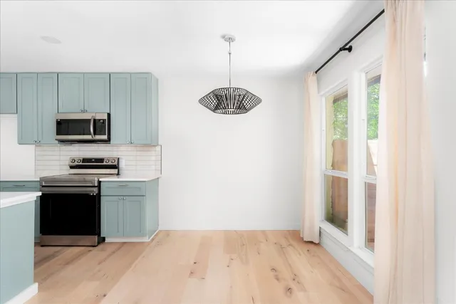 a kitchen with kitchen island a counter space a sink and appliances