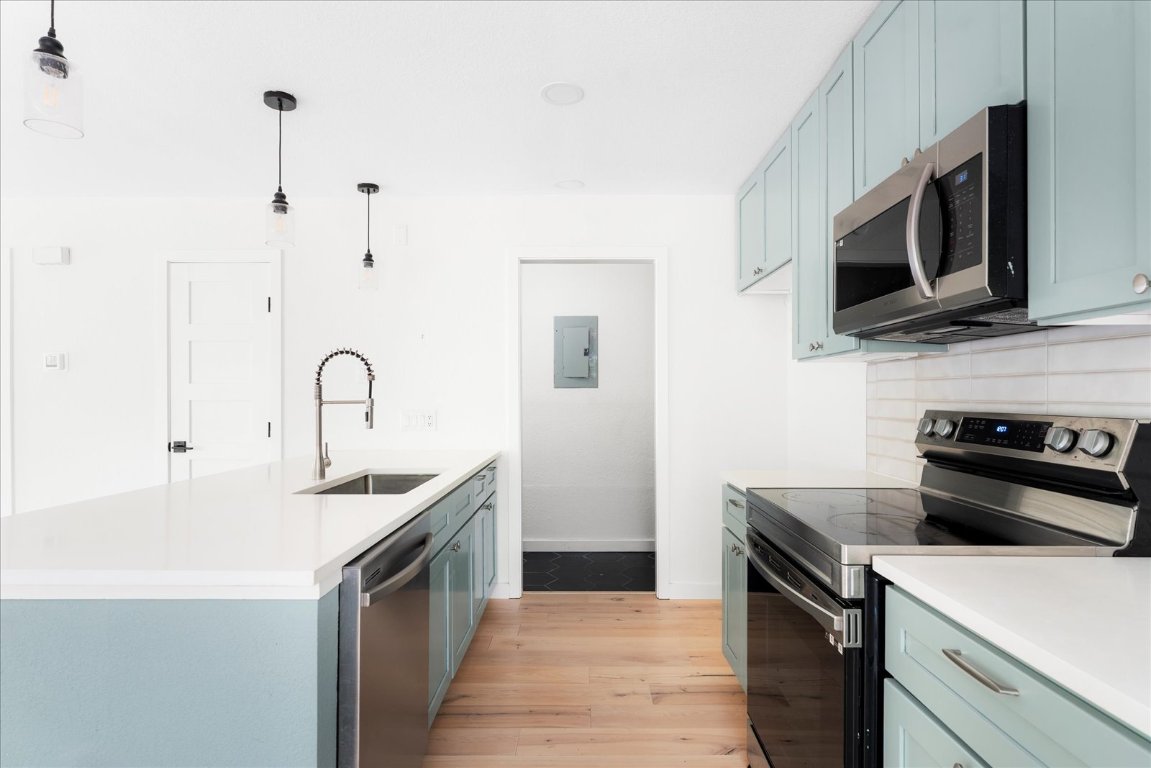 1511 Camp Craft Road, Unit D West Lake Hills, TX 78746 - Photo 19 of 29 a kitchen with stainless steel appliances a stove microwave and sink