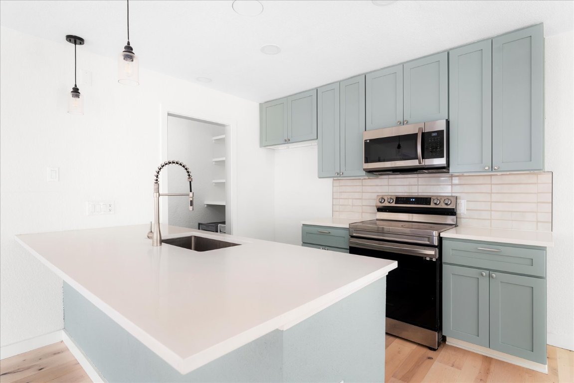 1511 Camp Craft Road, Unit D West Lake Hills, TX 78746 - Photo 20 of 29 a kitchen with stainless steel appliances a stove microwave and sink