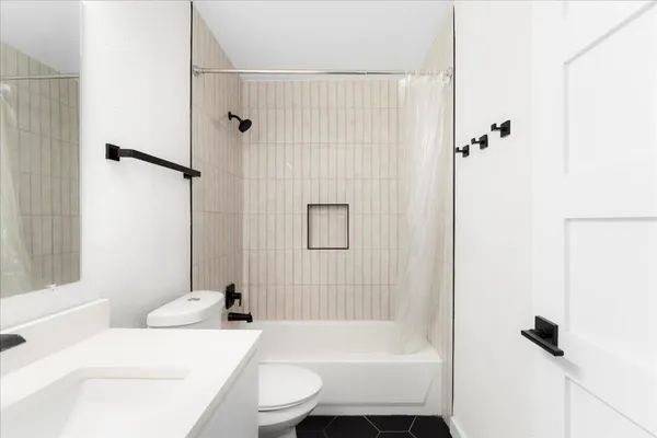 a bathroom with a sink toilet and shower