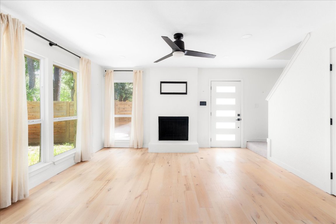 1511 Camp Craft Road, Unit D West Lake Hills, TX 78746 - Photo 8 of 29 a view of a livingroom with wooden floor and a fireplace