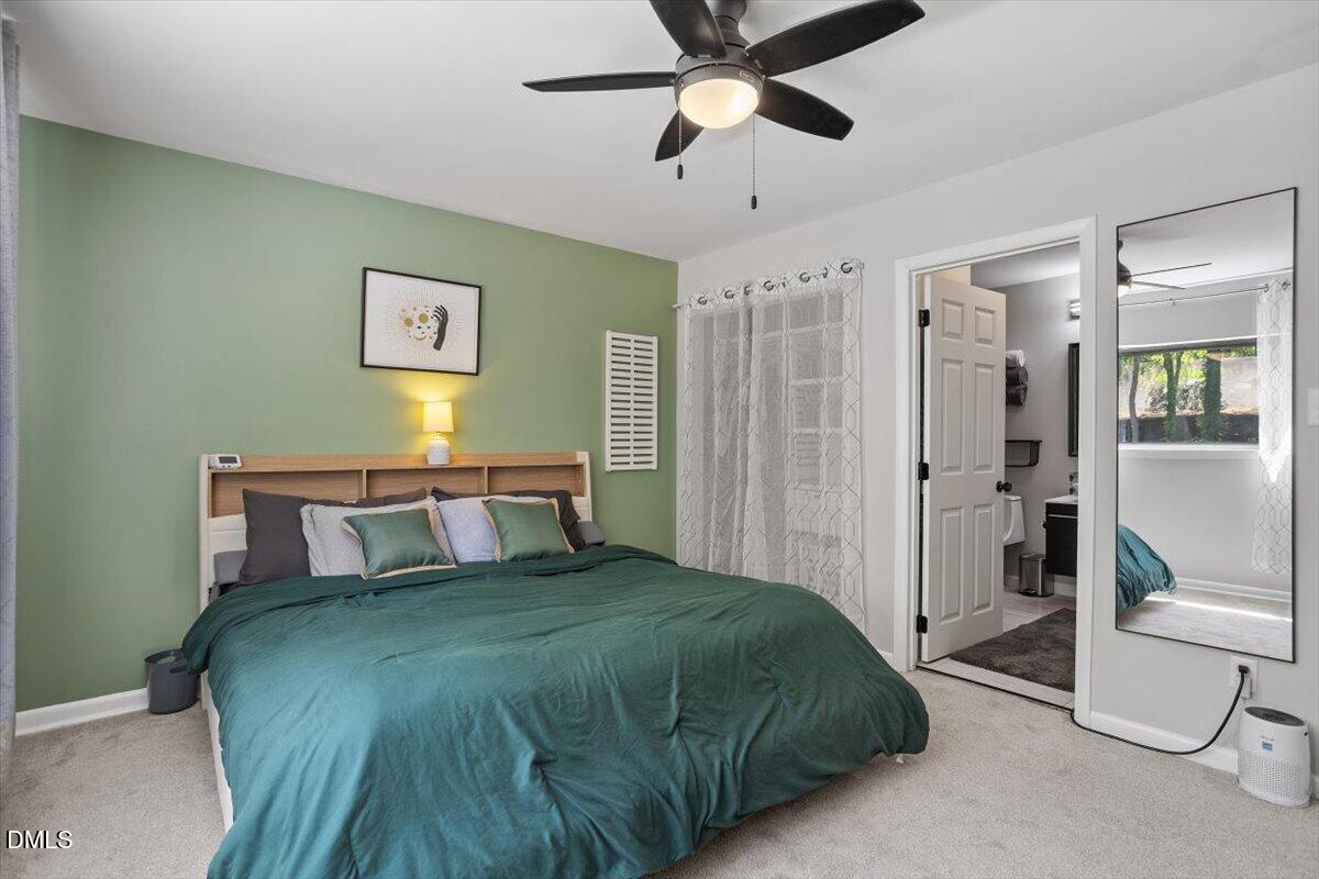 5045 Tall Pines Court Raleigh, NC 27609 - Photo 21 of 37 a bedroom with a bed and a chandelier