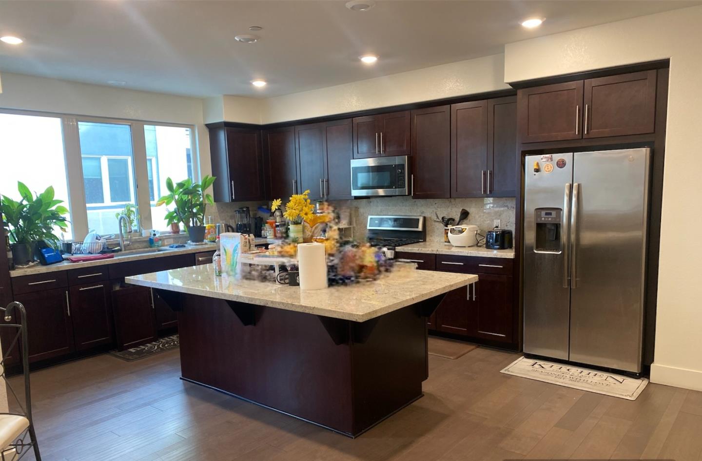 1625 Delano Street, Unit 21 Milpitas, CA 95035 - Photo 3 of 14 a kitchen with kitchen island stainless steel appliances a sink stove and refrigerator