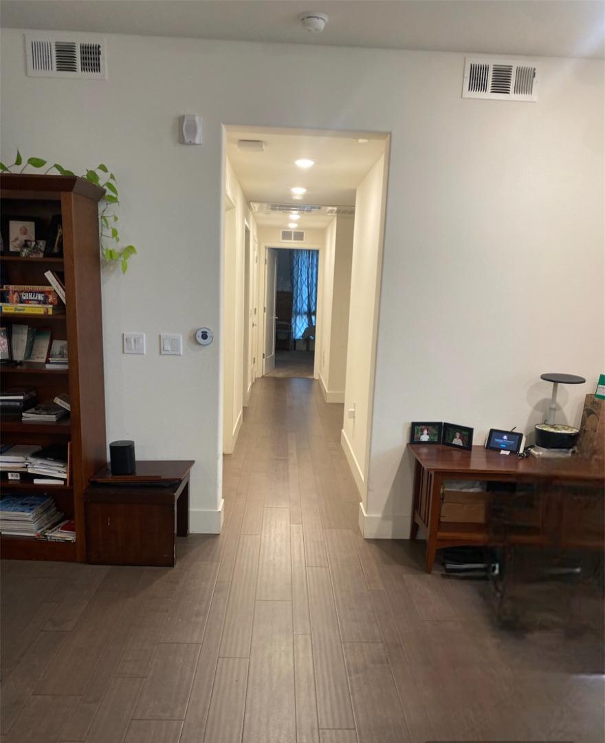 1625 Delano Street, Unit 21 Milpitas, CA 95035 - Photo 4 of 14 a view of a workspace with furniture and wooden floor