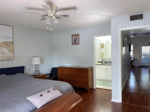 a bedroom with a bed and a view of kitchen