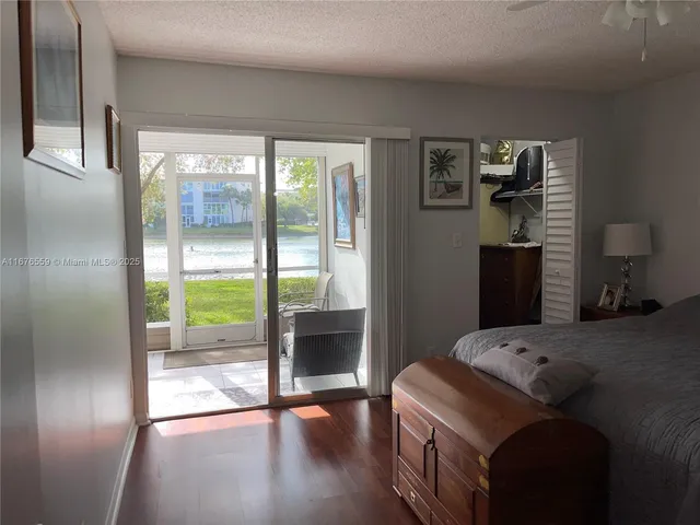a bedroom with a bed and a glass door