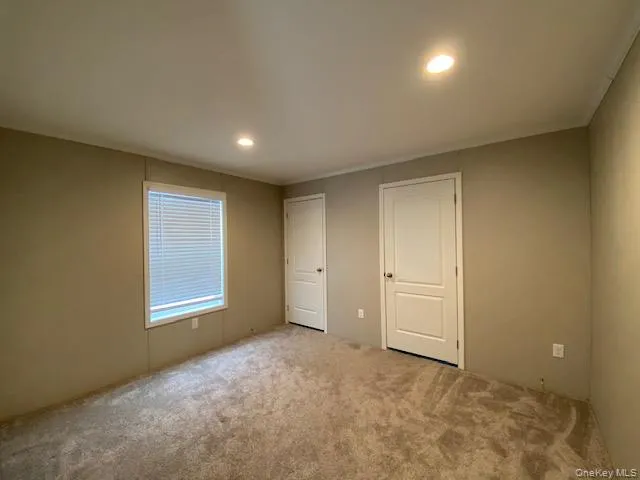 a view of an empty room and a window