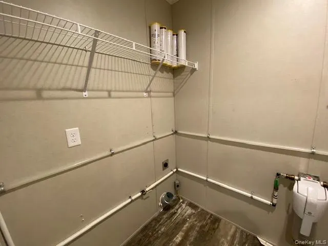 a view of storage and utility room with racks on the wall